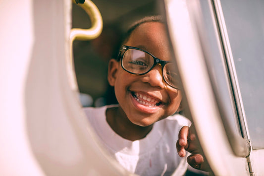A boy looking thoughtfully through a window