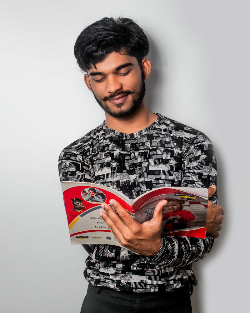 A man sits reading a book intently