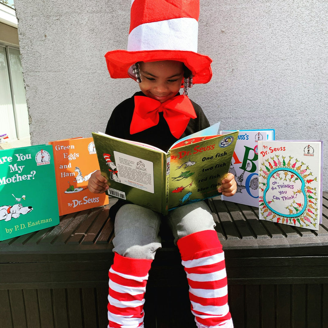 A girl in a red hat holding a newly arrived book