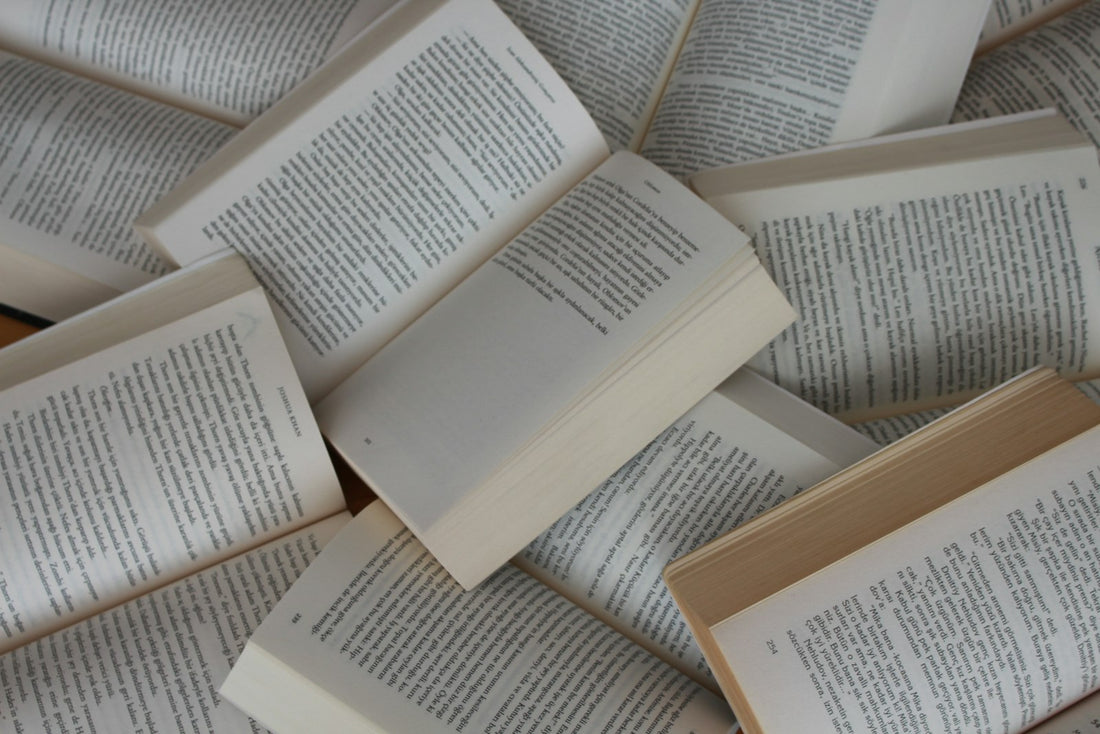 A pile of open, well-used paperback books