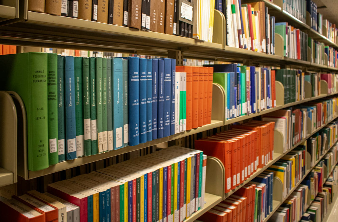 A tall library aisle lined with colorful children's books spine-out on the shelves