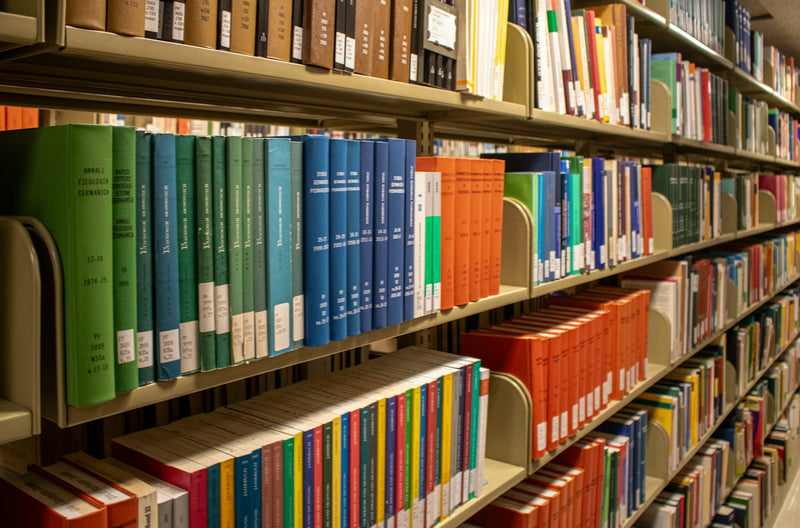 A tall library aisle lined with colorful children's books spine-out on the shelves